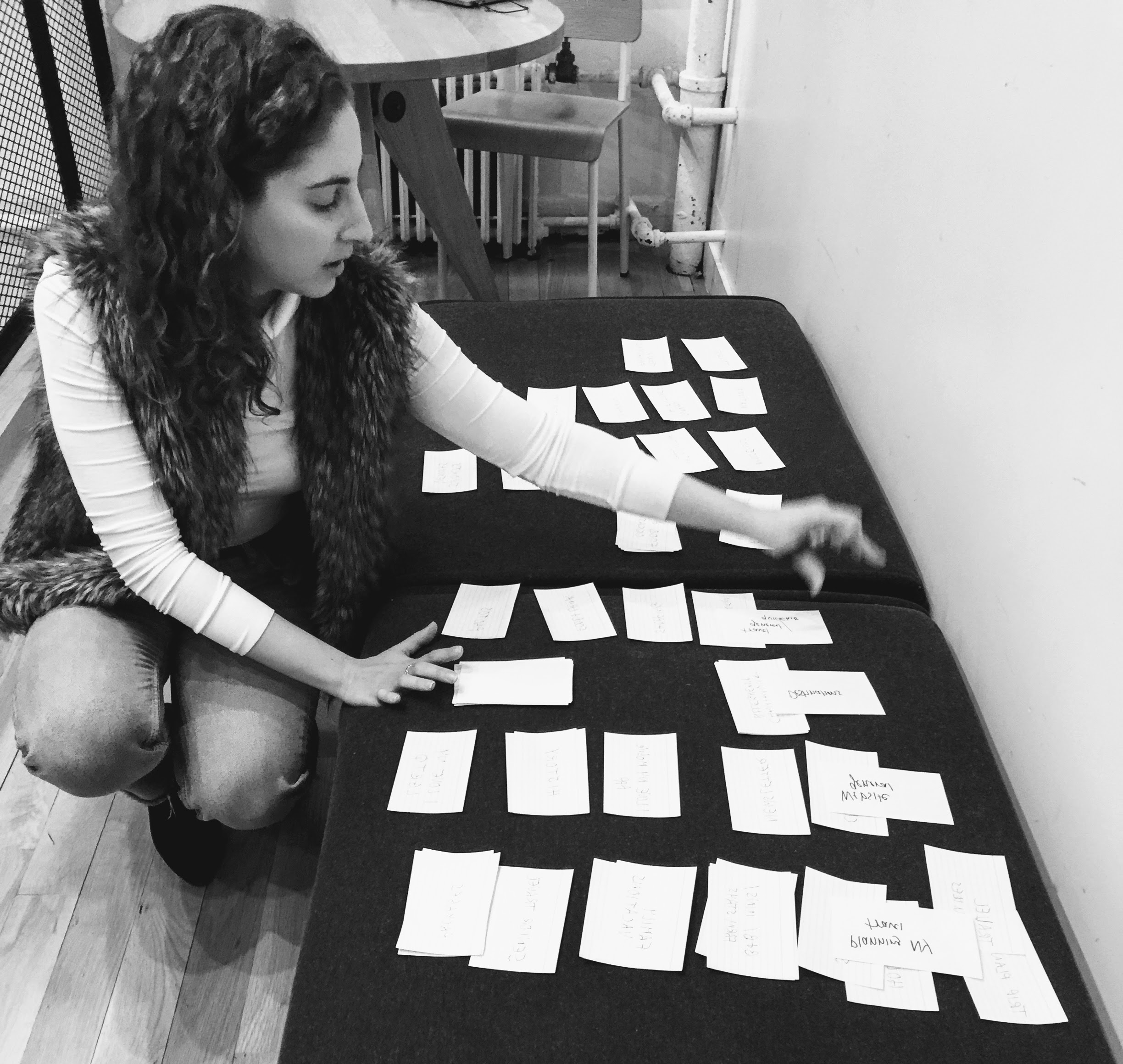 Black and white photo of woman doing card sort.
